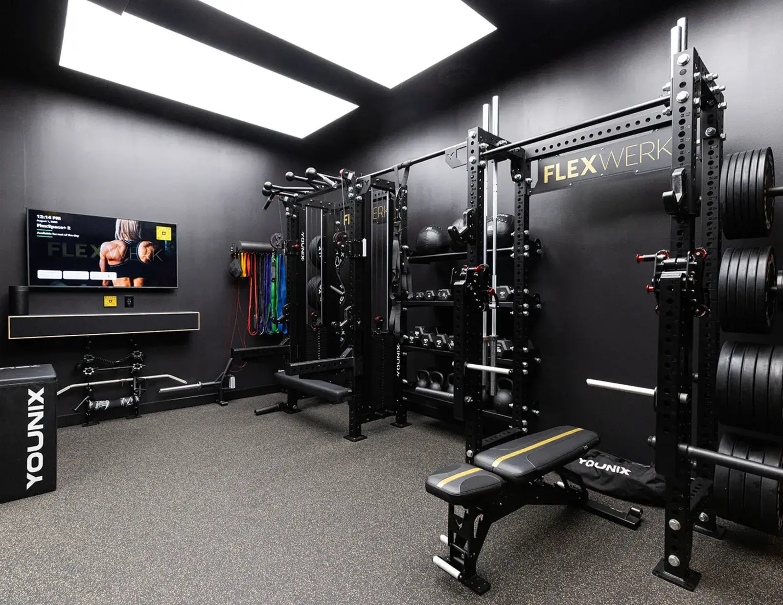 A FlexWerk private suite in Carmel with a lifting rack, bench and wall-mounted screen